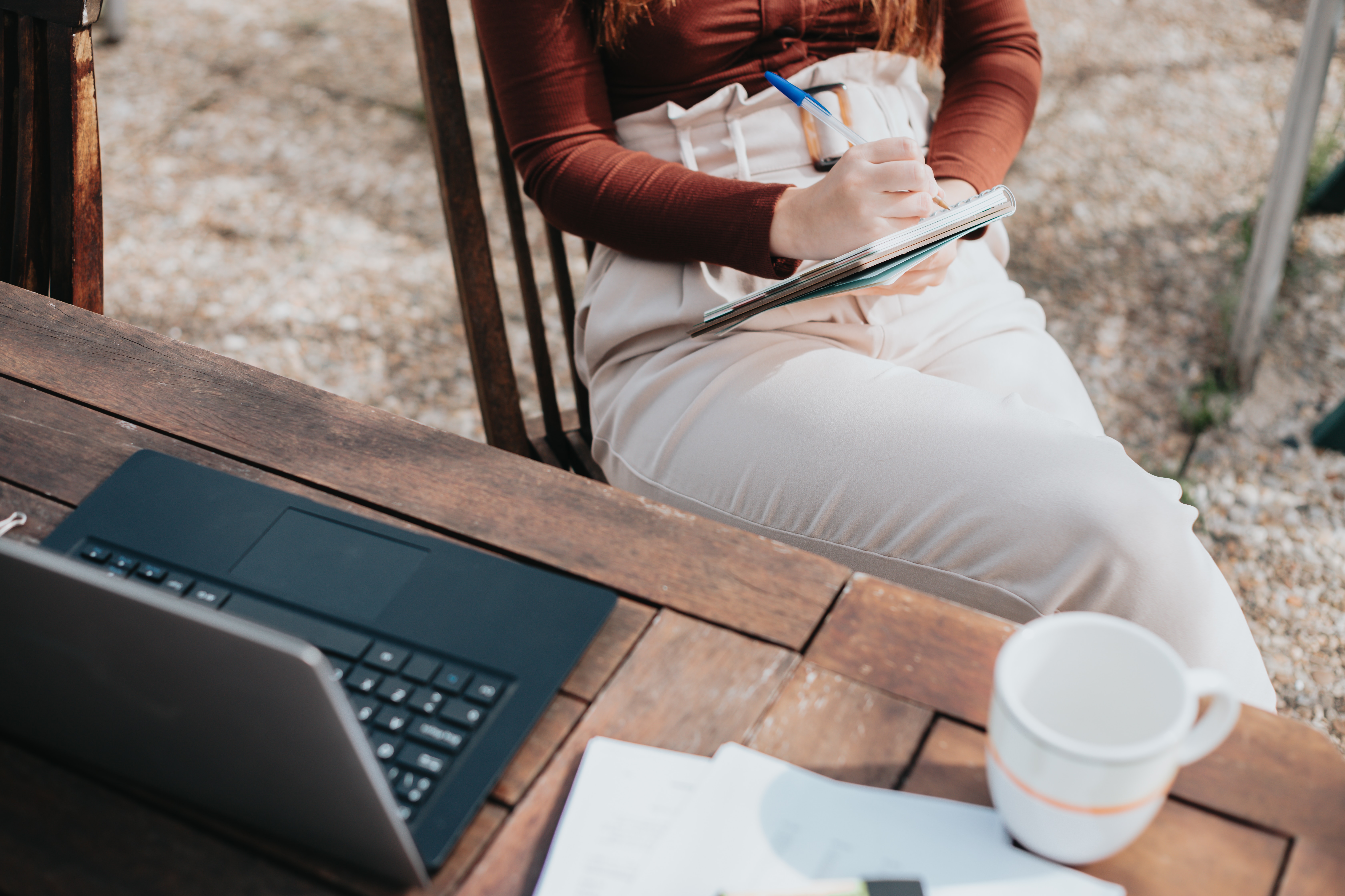 woman sitting at her computer taking notes