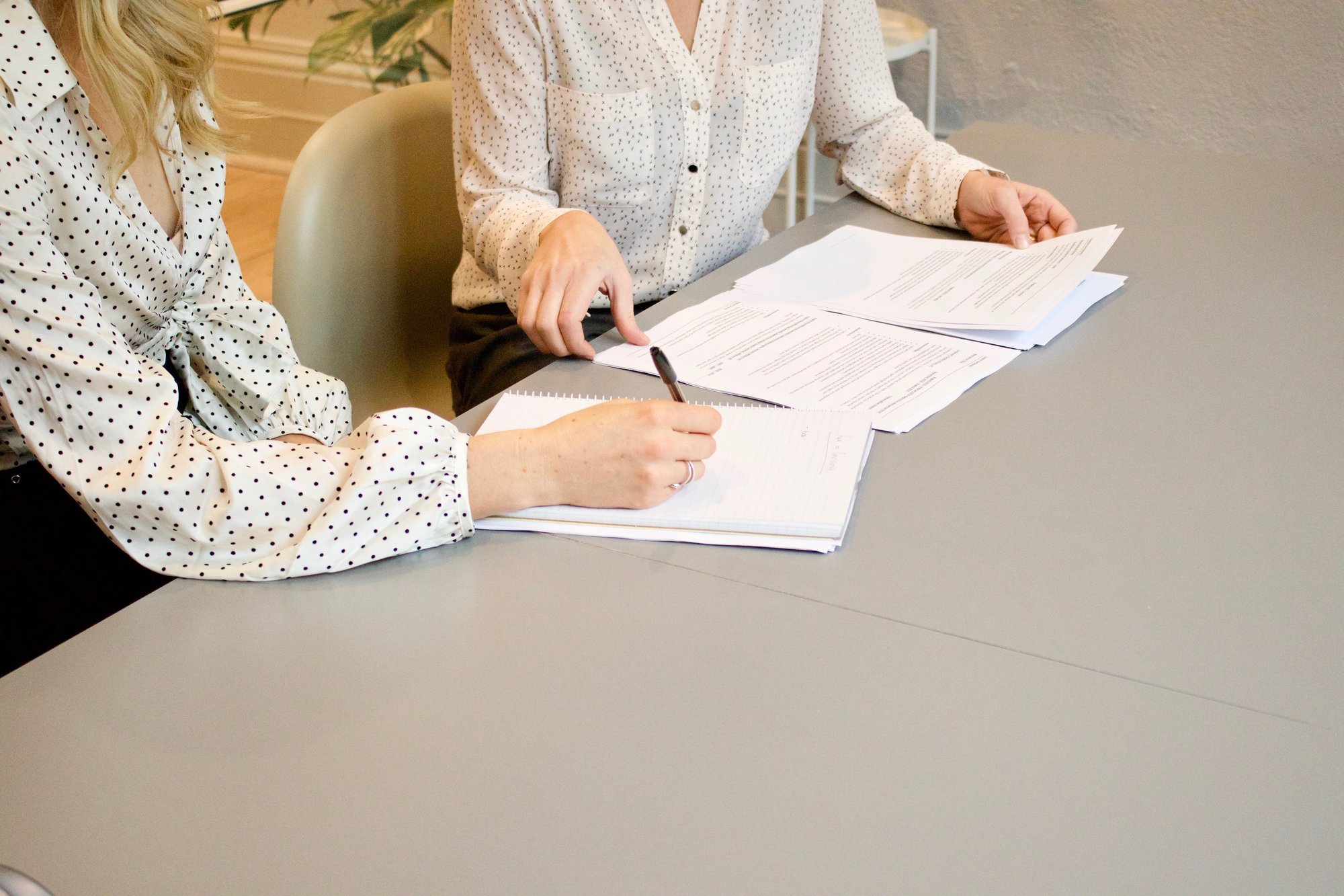 Two women looking at a resume Two women looking at a resume