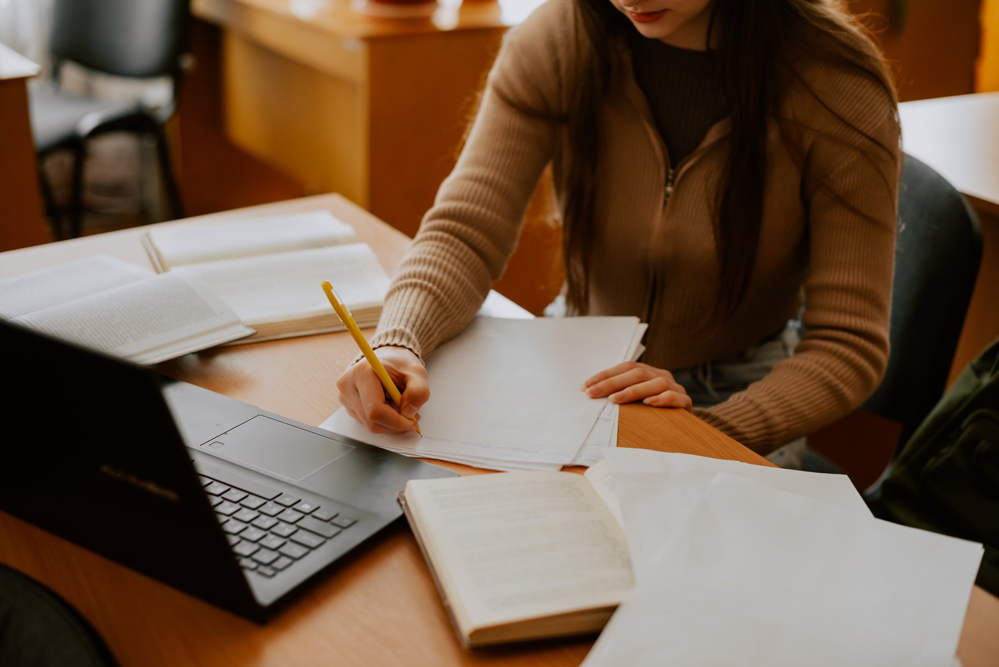 a-woman-writing-at-a-desk