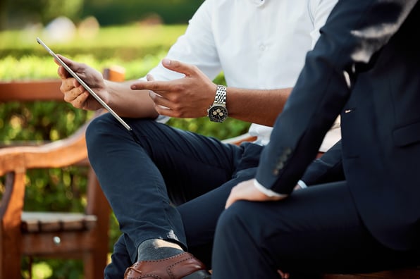 Two businesspeople talking at a park