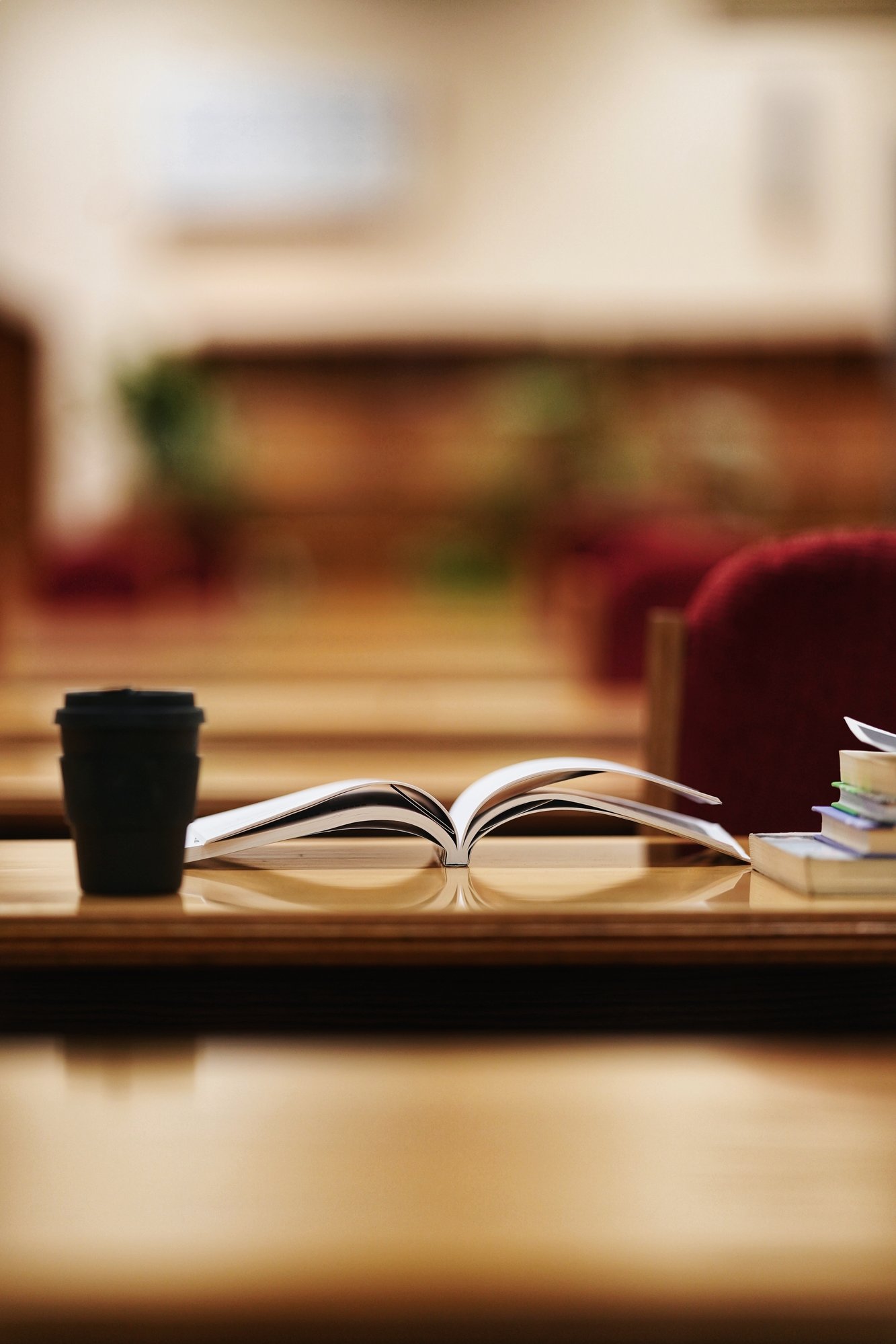 A book on a table and a cup of coffee