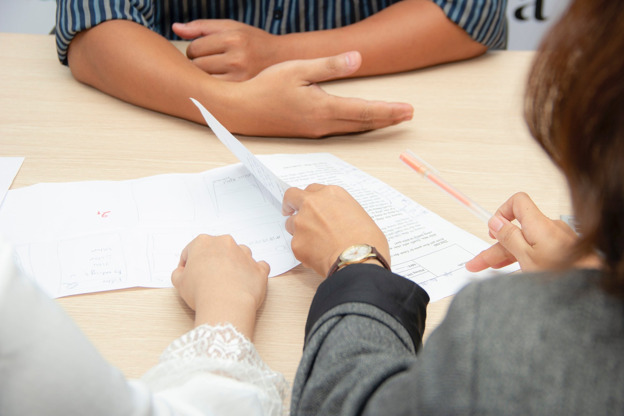 People at a table looking at resumes